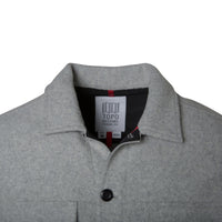 General product detail shot of men's wool shirt in gray showing collar and internal tag