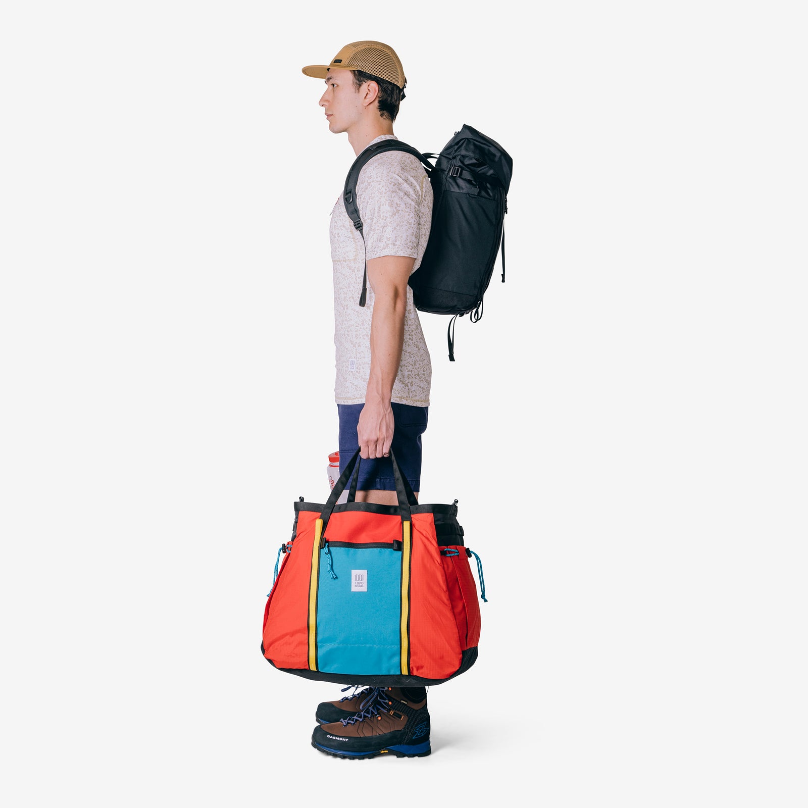 Side model shot of Topo Designs Mountain Pack 16L hiking backpack with internal laptop sleeve in lightweight recycled nylon "black".