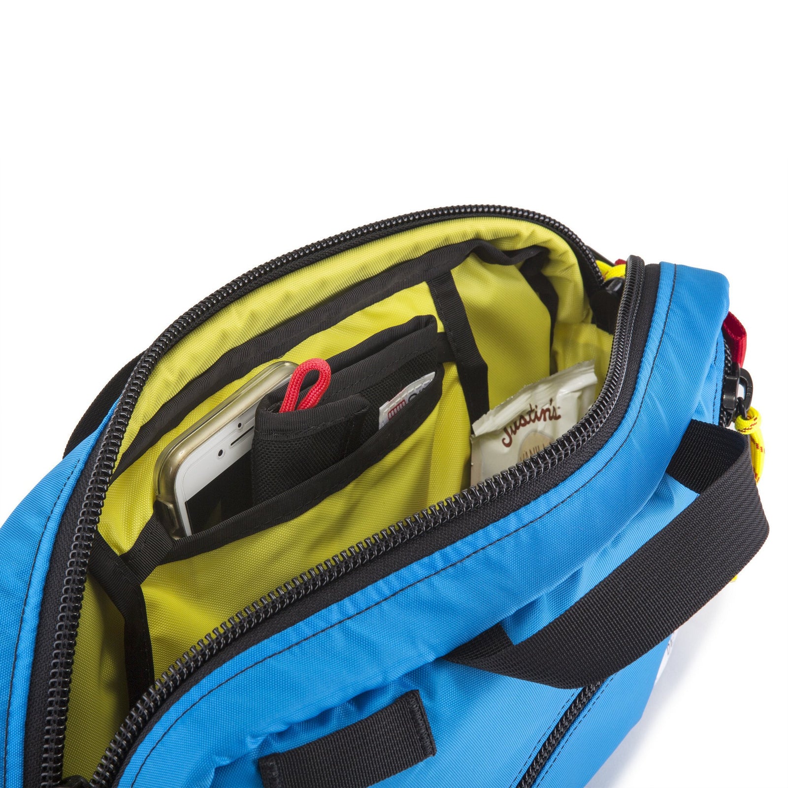 General detail shot of Topo Designs Quick Pack in Blue showing open main compartment and internal pockets.