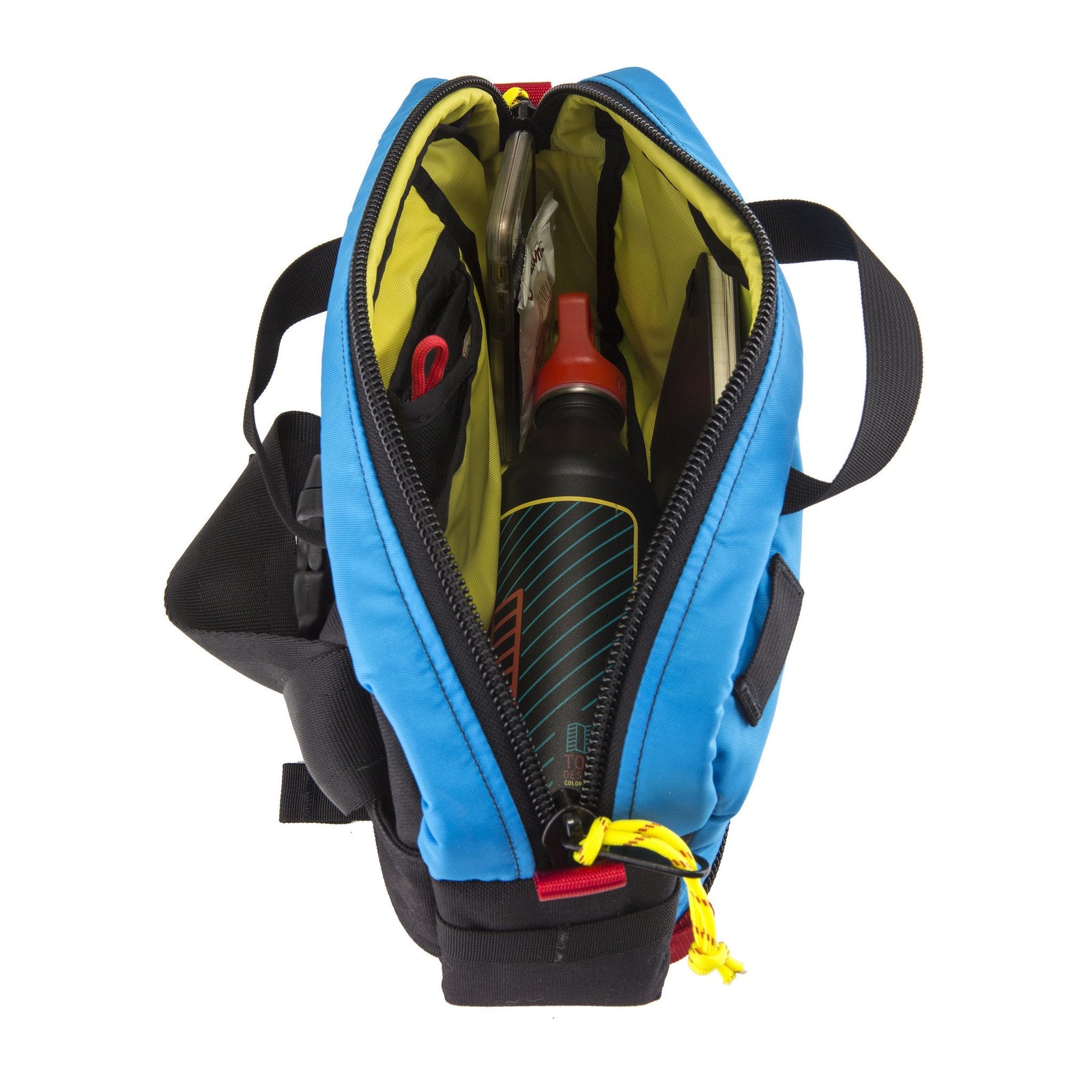 General top shot of Topo Designs Quick Pack in Blue showing full open main compartment and yellow lining.