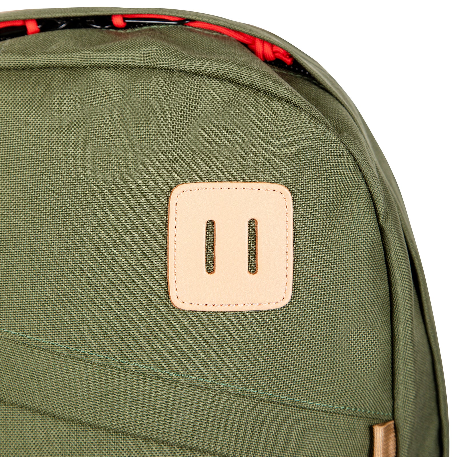 General shot of lash tab on Topo Designs Daypack Classic 100% recycled nylon laptop backpack for work or school in Olive green.