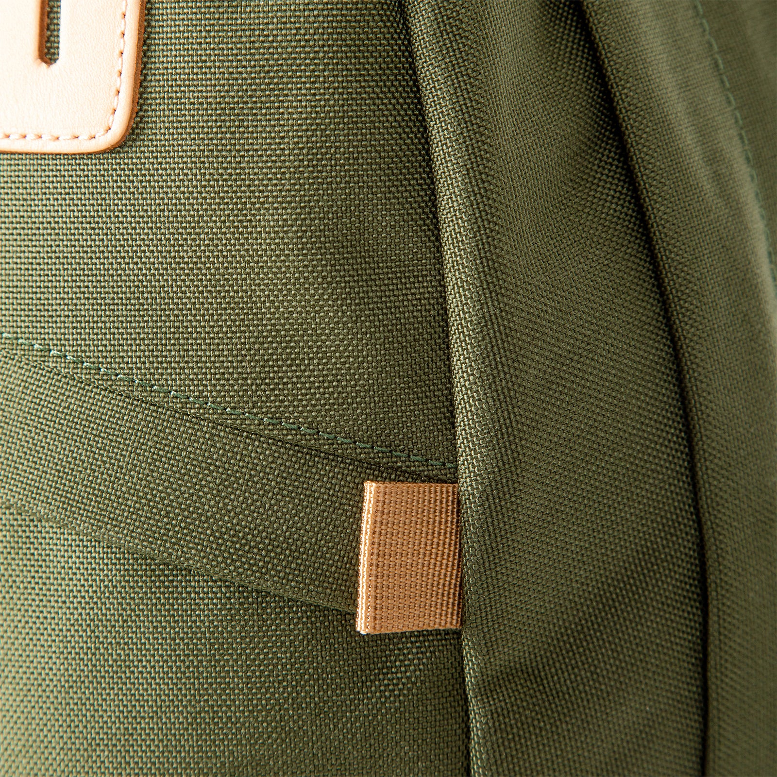 General shot of fabric detail on Topo Designs Daypack Classic 100% recycled nylon laptop backpack for work or school in Olive green.