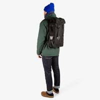 General shot of Topo Designs Klettersack Heritage Canvas backpack in Black Canvas / Black Leather on model.