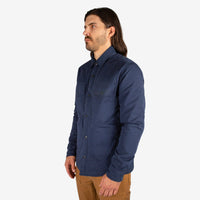 General close-up 3/4 front model shot of Men's Topo Designs Insulated Shirt Jacket in Navy blue.
