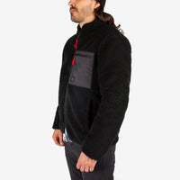 General close-up side model shot of Topo Designs Men's Sherpa Jacket in Black showing sherpa fleece side.