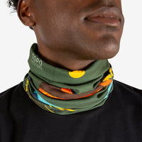 General shot of Topo Designs Neck Gaiter in Moab olive green print on model showing around neck.