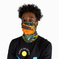General shot of Topo Designs Neck Gaiter in Moab olive green print on model showing nose and mouth covered.