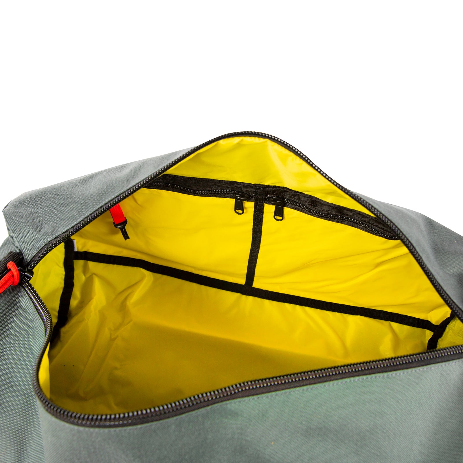 General shot of interior detail shot of Topo Designs Classic Duffel 20" in Charcoal gray showing yellow inside lining, internal zipper pockets, and red key clip.