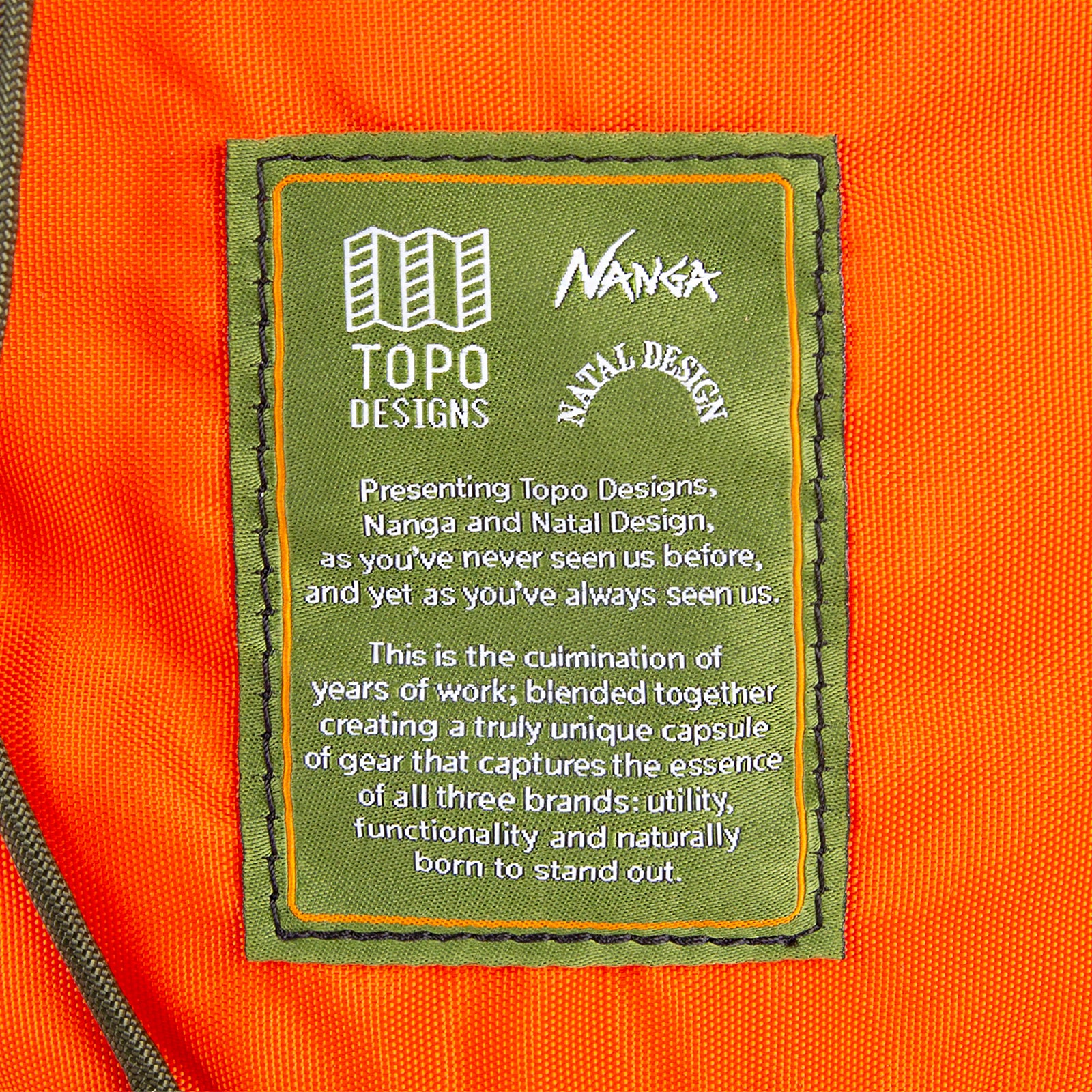 Detail shot of Topo Designs x Nanga x Natal Designs Rover Shoulder Bag in Camo showing collaboration tag.