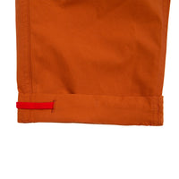 General detail shot of Topo Designs Women's Lightweight Tech Pants in Brick orange showing inside of pant leg cuff