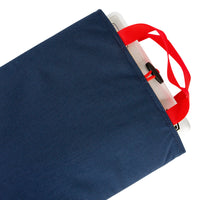 General shot of Topo Designs padded Laptop Sleeve in Navy blue showing computer in sleeve and red carry handles.