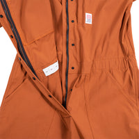 General detail shot of the Topo Designs Women's Coverall in Brick showing front zipper, and snaps open.