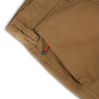 General shot of Topo Designs Men's Global Pants lightweight cotton nylon travel pants in Dark Khaki brown showing zipper hand pockets.