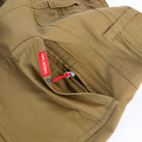 General shot of Topo Designs Men's Global Pants lightweight cotton nylon travel pants in Dark Khaki brown showing hidden zipper back pocket.