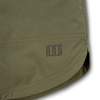 General shot of Topo Designs Men's River Shorts Lightweight quick dry swim trunks showing map logo on leg in Olive green.