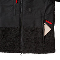 General detail product shot of the men's subalpine fleece in black showing open zip pocket.