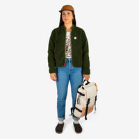 Front model shot of the Topo Designs women's sherpa jacket in "olive" green showing the sherpa fleece side.